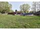 Spacious backyard with in-ground pool, lush lawn, mature trees and patio at 1000 Riverview Dr, Martinsville, IN 46151