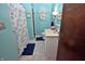 Charming bathroom with blue walls, a decorative shower curtain, and a white single sink vanity at 1000 Riverview Dr, Martinsville, IN 46151