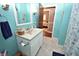 Bathroom with blue walls, a white single sink vanity, decorative towels and neutral flooring at 1000 Riverview Dr, Martinsville, IN 46151