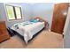 Bedroom with a comfortable bed, wood furniture, and a window letting in natural light at 1000 Riverview Dr, Martinsville, IN 46151