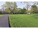 Spacious front yard with mature trees, long driveway, and view of the house at 1000 Riverview Dr, Martinsville, IN 46151