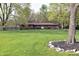 Ranch-style brick home with a well-manicured lawn and mature shade trees at 1000 Riverview Dr, Martinsville, IN 46151
