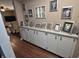 Neutral hallway with custom cabinetry and granite countertop display shelf with Gathering photos and decor at 1000 Riverview Dr, Martinsville, IN 46151