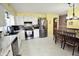 Spacious kitchen with updated appliances, light countertops, and an adjacent dining area at 1000 Riverview Dr, Martinsville, IN 46151