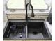 Close-up of a modern black kitchen sink with a stylish faucet and granite countertop at 1000 Riverview Dr, Martinsville, IN 46151
