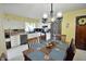 Inviting eat-in kitchen with modern appliances, a dining table, and a stylish light fixture at 1000 Riverview Dr, Martinsville, IN 46151