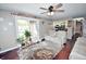 Inviting living room with sliding glass doors, ceiling fan, and comfortable seating at 1000 Riverview Dr, Martinsville, IN 46151