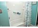 Clean shower with a white surround, safety bar, and decorative shower curtain in the bathroom at 1000 Riverview Dr, Martinsville, IN 46151