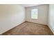 Neutral bedroom with sliding closet doors and a single window for natural light at 10822 Cape Coral Ln, Indianapolis, IN 46229