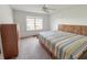 Spacious bedroom featuring neutral carpet, ceiling fan, and a large window for natural light at 10822 Cape Coral Ln, Indianapolis, IN 46229