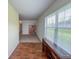 Hallway view with modern flooring, shelving, and natural light at 10822 Cape Coral Ln, Indianapolis, IN 46229