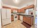 Efficient kitchen with sleek appliances, wood cabinets, and a cozy dining area at 10822 Cape Coral Ln, Indianapolis, IN 46229