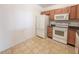 Efficient kitchen with white appliances and wood cabinets at 10822 Cape Coral Ln, Indianapolis, IN 46229