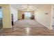 Open-concept living area boasting carpet and wood-look flooring and seamless transitions to other rooms at 10822 Cape Coral Ln, Indianapolis, IN 46229