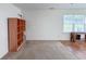 Living room with neutral carpet, natural light, and built-in shelving at 10822 Cape Coral Ln, Indianapolis, IN 46229