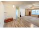 Light-filled living space with wood-look flooring and a ceiling fan, open to the dining area at 10822 Cape Coral Ln, Indianapolis, IN 46229