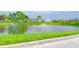 Scenic view of a tranquil pond with a fountain, surrounded by lush green landscaping at 10822 Cape Coral Ln, Indianapolis, IN 46229