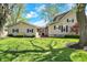 Exterior view showing a well-maintained backyard, lush lawn, and connecting door at 110 W Buckeye St, Cicero, IN 46034
