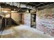Unfinished basement with brick walls and concrete floor, offering potential for customization at 110 W Buckeye St, Cicero, IN 46034