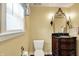 Elegant bathroom featuring a decorative mirror, wooden vanity and toilet at 110 W Buckeye St, Cicero, IN 46034