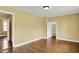 Open bedroom featuring hardwood floors and access to other rooms at 110 W Buckeye St, Cicero, IN 46034