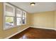 Bright bedroom filled with natural light from three large windows and hardwood floors at 110 W Buckeye St, Cicero, IN 46034