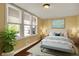 Comfortable bedroom with three windows, natural light, and a soft blue accent bench at 110 W Buckeye St, Cicero, IN 46034