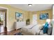 Bedroom with wood floors, white dresser, and serene wall art creating a peaceful atmosphere at 110 W Buckeye St, Cicero, IN 46034