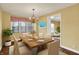 Formal dining room features a wooden table, chandelier, and bright natural light at 110 W Buckeye St, Cicero, IN 46034