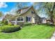 Well-maintained two-story home with lush green lawn and mature trees, creating a serene setting at 110 W Buckeye St, Cicero, IN 46034