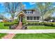 Charming home featuring neat landscaping, a brick pathway, and mature trees offering a welcoming curb appeal at 110 W Buckeye St, Cicero, IN 46034
