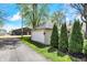 Detached single-car garage complemented by mature trees, enhancing the curb appeal of this property at 110 W Buckeye St, Cicero, IN 46034