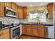 Well-equipped kitchen with stainless steel appliances, granite countertops, and wooden cabinets at 110 W Buckeye St, Cicero, IN 46034