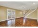 Open living area with hardwood floors, staircase, and French doors providing ample natural light at 110 W Buckeye St, Cicero, IN 46034