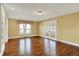 Well-lit living room featuring hardwood floors, built-in shelving, and a window with tasteful curtains at 110 W Buckeye St, Cicero, IN 46034
