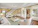 Inviting living room with a staircase, shelving, light-colored furniture, and hardwood floors at 110 W Buckeye St, Cicero, IN 46034