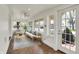 Bright sunroom with tile floor, neutral furniture, and many windows bringing in natural light at 110 W Buckeye St, Cicero, IN 46034