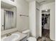 Bathroom with sink, toilet, mirror, and a shower/tub with a patterned shower curtain at 11603 Presidio Dr, Indianapolis, IN 46235