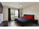 Bright bedroom featuring wood floors, a gray upholstered bed, and a window with natural light at 11603 Presidio Dr, Indianapolis, IN 46235