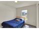 Bedroom featuring wood floors, a window with natural light, and a simple bed frame at 11603 Presidio Dr, Indianapolis, IN 46235