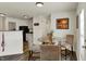 A charming dining area situated next to the kitchen showcases a glass table with seating for three at 11603 Presidio Dr, Indianapolis, IN 46235