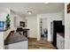 Clean kitchen with gray cabinets and stainless steel dishwasher, adjacent to a convenient laundry area at 11603 Presidio Dr, Indianapolis, IN 46235