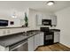 Functional kitchen offers a black range and microwave and gray cabinets, perfect for preparing meals at 11603 Presidio Dr, Indianapolis, IN 46235