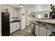 Well-lit kitchen includes stainless steel dishwasher and sink with modern gray cabinets for ample storage at 11603 Presidio Dr, Indianapolis, IN 46235