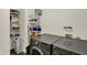 Well-organized laundry room features a modern washer and dryer set, along with generous shelving at 11603 Presidio Dr, Indianapolis, IN 46235