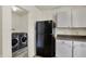 A laundry room provides convenience with modern washer and dryer, complemented by ample shelving at 11603 Presidio Dr, Indianapolis, IN 46235