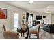 Bright living room features vaulted ceilings, fireplace, and adjacent dining area for easy entertaining at 11603 Presidio Dr, Indianapolis, IN 46235