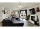 Bright, open living room featuring a fireplace, modern furniture and a view to the dining area at 11603 Presidio Dr, Indianapolis, IN 46235