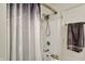 Close-up of a shower/tub showcasing a shower head and patterned curtain at 11603 Presidio Dr, Indianapolis, IN 46235