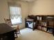 Bedroom area with wood rocking chair and desk, as well as a wooden bookcase at 11875 Buck Creek Cir, Noblesville, IN 46060
